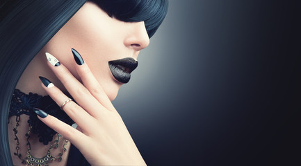 Fashion Halloween model girl with trendy gothic black hairstyle, makeup and manicure