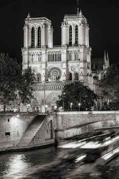 Fototapeta Notre Dame de Paris cathedral at night with the Seine River Black and White). Ile de La Cite. Paris, France