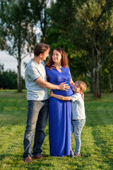 Fototapeta premium Happy pregnant family of three expecting new baby