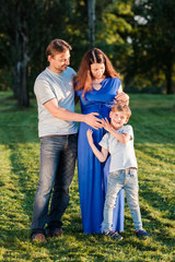 Fototapeta premium Happy pregnant family of three expecting new baby