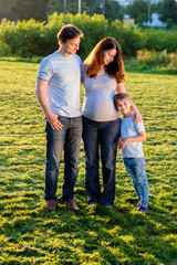 Fototapeta premium Happy pregnant family of three expecting new baby