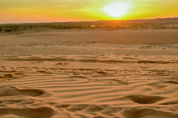 Beautiful white sand dunes ripples and footprint in sunrise morning, White Sand Dune at Muine, Vietnam. Vacation concept background.