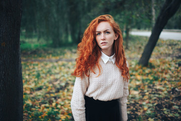 redhead girl in autumn park