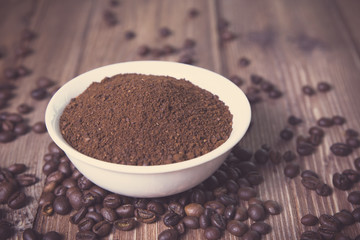 bowl with ground coffee and coffee beans