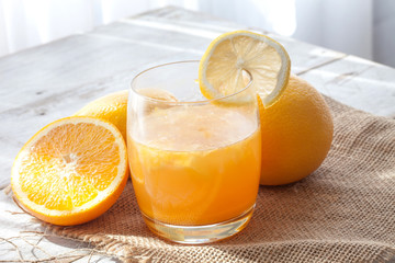 Slice mandarin. Fresh orange juice on the table