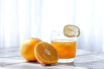 Slice mandarin. Fresh orange juice on the table