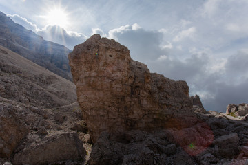 Giant boulder with the back of the sun near Fontananegra Pass, Dolomites, Cortina d'Ampezzo, Italy