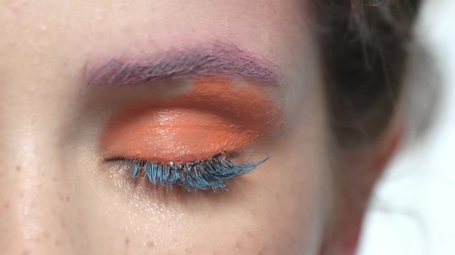 Eye makeup macro. Bright orange eyeshadow.