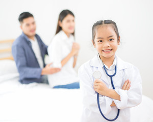 Fototapeta premium Little doctor, Cute little asian girl dressed like a doctor at home