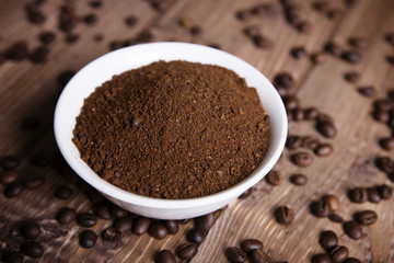 bowl with ground coffee and coffee beans