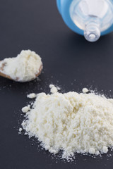 Powdered milk dairy food for baby and Baby bottle. Top view.