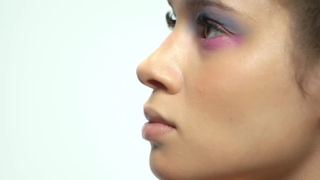 Hand of visagist applying makeup. Female face, beautiful eyeshadow.