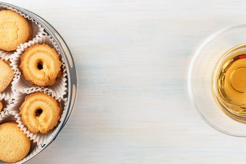 Overhead view of Danish butter cookies with tea and copyspace