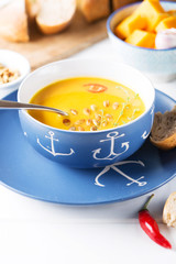 Creamy pumpkin soup on the table, selective focus, vertical
