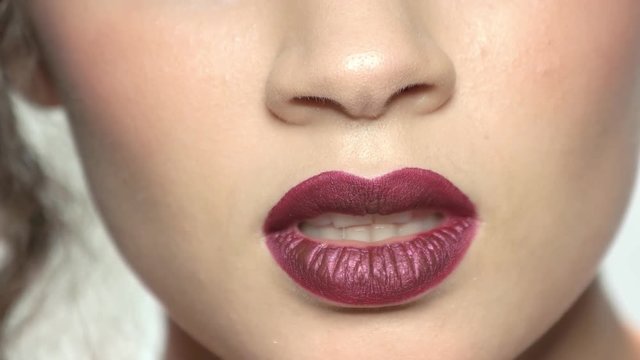 Dark red lips. Mouth of young woman, makeup.