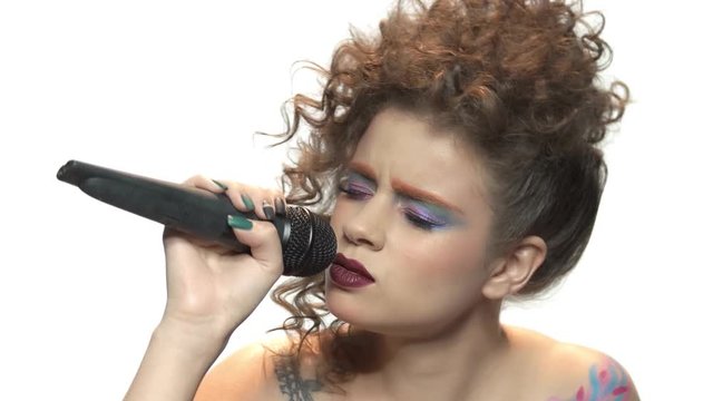 Attractive woman singing isolated. Female singer with microphone.