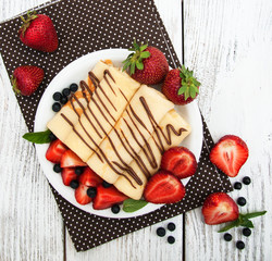 crepes with strawberries and chocolate sauce