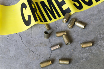 Crime scene close up of crime scene tape and bullet casings