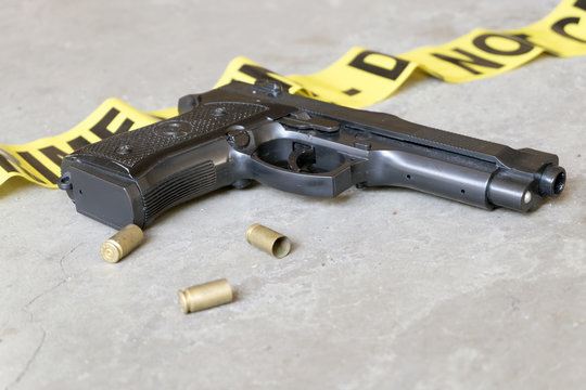 Crime Scene Concept With Gun And Three Casings