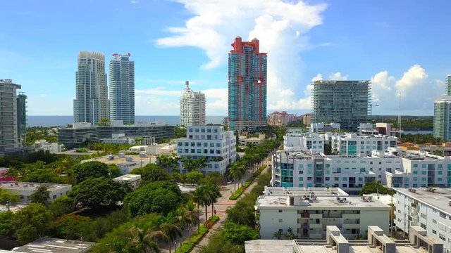 Aerial approach establishing shot Miami Beach highrise condominiums