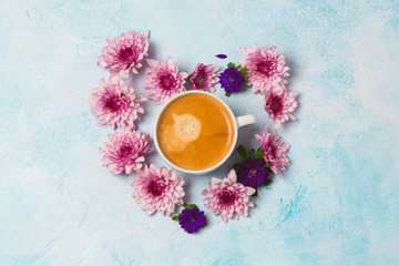 Fototapeta na wymiar Coffee cup and flowers in heart shape