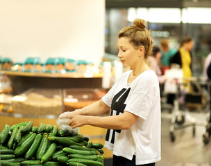 Middle-age woman buying vegetables at the market
