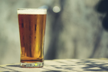 Glass of beer on on a wooden table