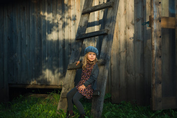 child sitting wooden stairs countryside