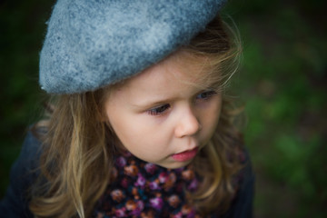 cute little girl in a beret outdoor