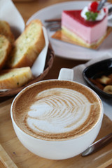 Hot cappuccino, biscuit, cake and bread in morning time.