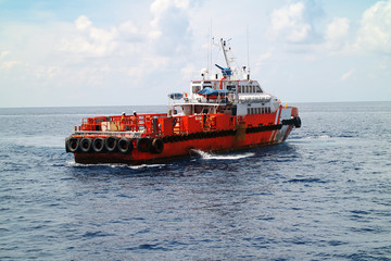 Fototapeta premium Supply boat transfer cargo to oil and gas industry and moving cargo from the boat to the platform