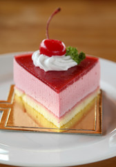 Strawberry cheesecake on white plate.
