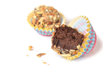 Chocolate ganache truffles with almond on white background - isolated