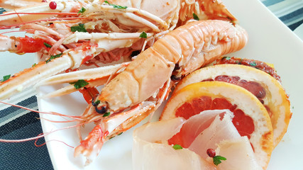 seafood appetizer with prawn, tuna carpaccio and grapefruit slices