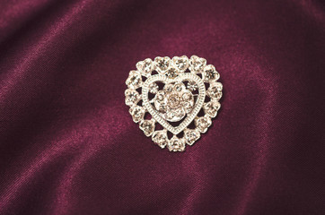 Brooch silver heart with diamonds on silk fabric