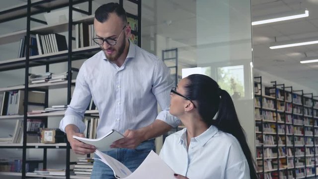 Young man and woman in office