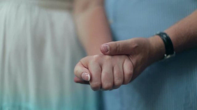 Man takes a woman by the hand