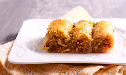 Baklava with pistachios and honey on plate