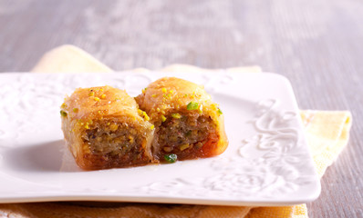 Baklava with pistachios and honey on plate