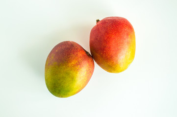 2 ripe mangoes isolated on white