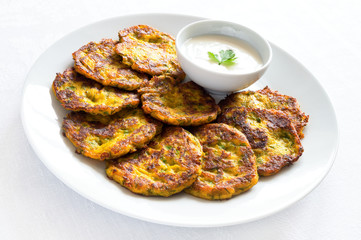 pumpkin fritters with dill, parsley, and garlic served with yogurt