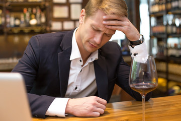 Businessman Hangover suffering when he drunk wine at Bat, Man with alcoholism concept.