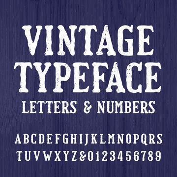 Vintage typeface. Retro alphabet font. Type letters and numbers on a rough wooden background. Stock vector typeset for your headers or any typography design.