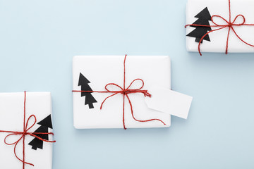 White Christmas gifts with red bow and a label.