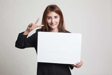 Fototapeta premium Young Asian business woman show victory sign with blank sign.
