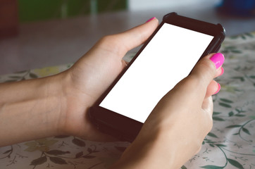 Mobile phone with blank screen in female hands.