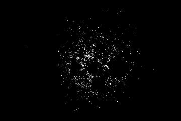 Abstract grainy texture isolated on black background. Top view. Dust, sand blow or bread crumbs. Silhouette of food flakes such as salt or almond or wheat flour spread on the flat surface or table.