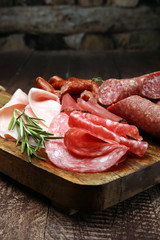 Marble cutting board with prosciutto, bacon, salami and sausages