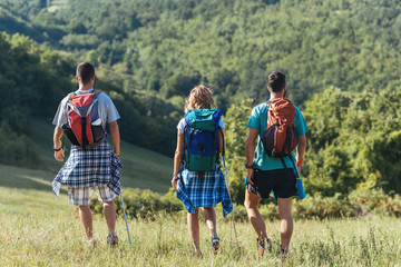 Hikers with backpacks walking at nature