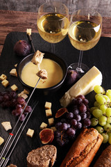Gourmet Swiss fondue dinner on a winter evening with assorted ch
